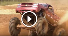 Mad Chevy Truck Riding On Two Wheels In A Mud Pit