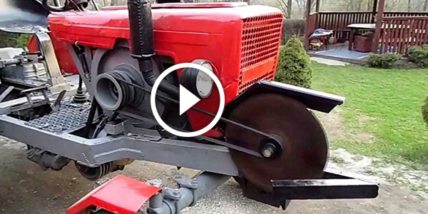 Tractor with a chainsaw to cut firewood