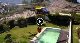 Amazing helicopter pilot taking water from swimming pool