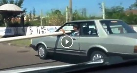 crazy brazilian carrying a pipe in a car