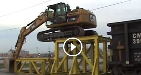 Cat 319D LN climbing onto rail car