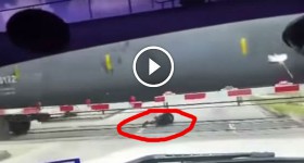 fool tries to cross under a train
