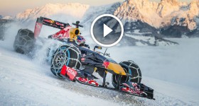 Max Verstappen driving a Red Bull RB7 F1 car on snow front three quarters