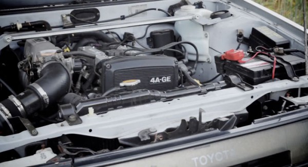 Open car hood with engine view