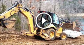 Cat 420E Backhoe Moving 7000 Pound Limestone Block