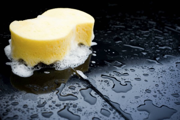 hand-washing a car with a sponge