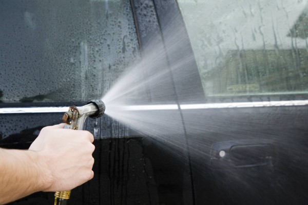 hand washing car with hose