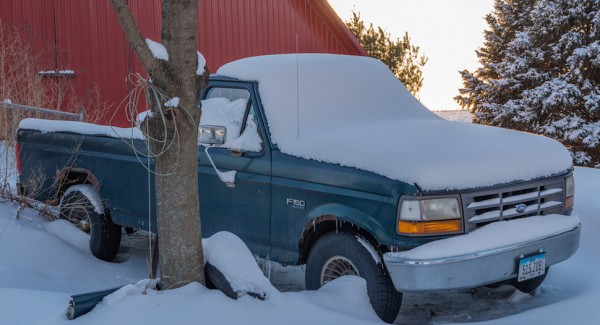 snow covered ford f150 side three quarters