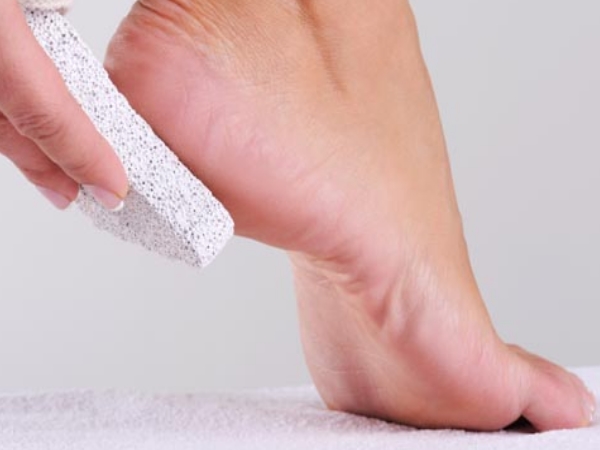 rubbing feet with  with pumice stone.