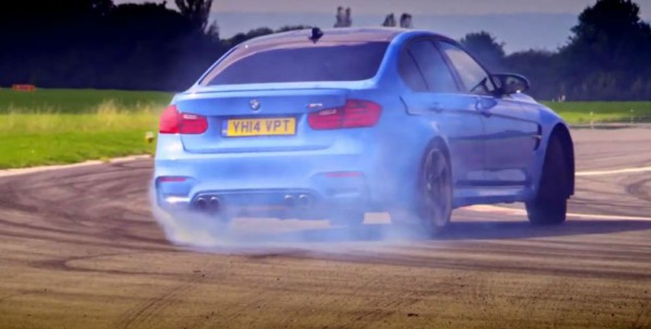 BMW M3 drifting rear three quarters view