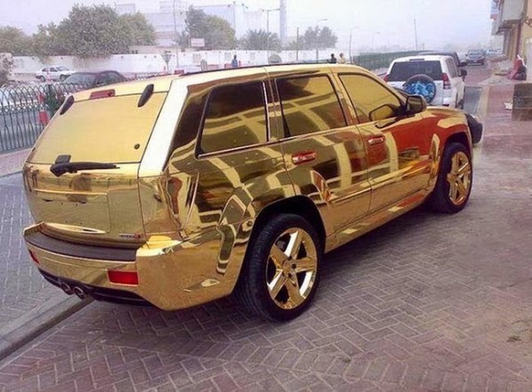 gold suv with gold rims reat three quarters