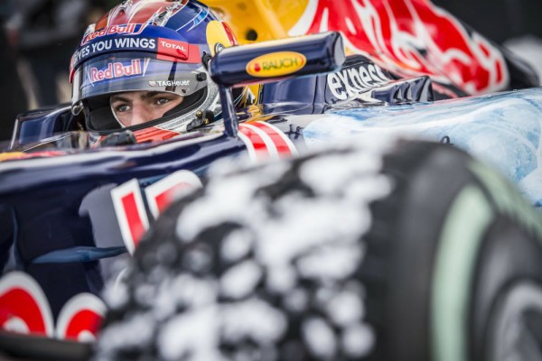 Max Verstappen driving a Red Bull RB7 F1 car on snow close up