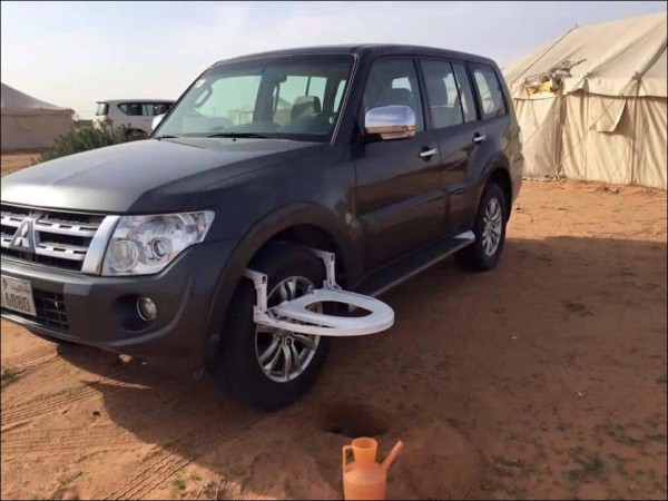 Mitsubishi SUV with toilet seat on the front wheel